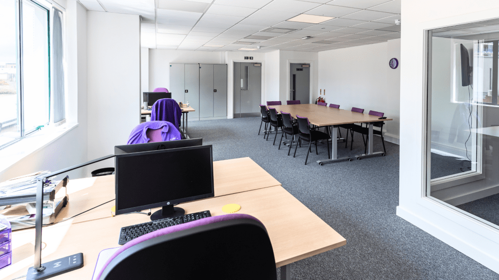 Modern office reception with a bespoke dark slatted desk