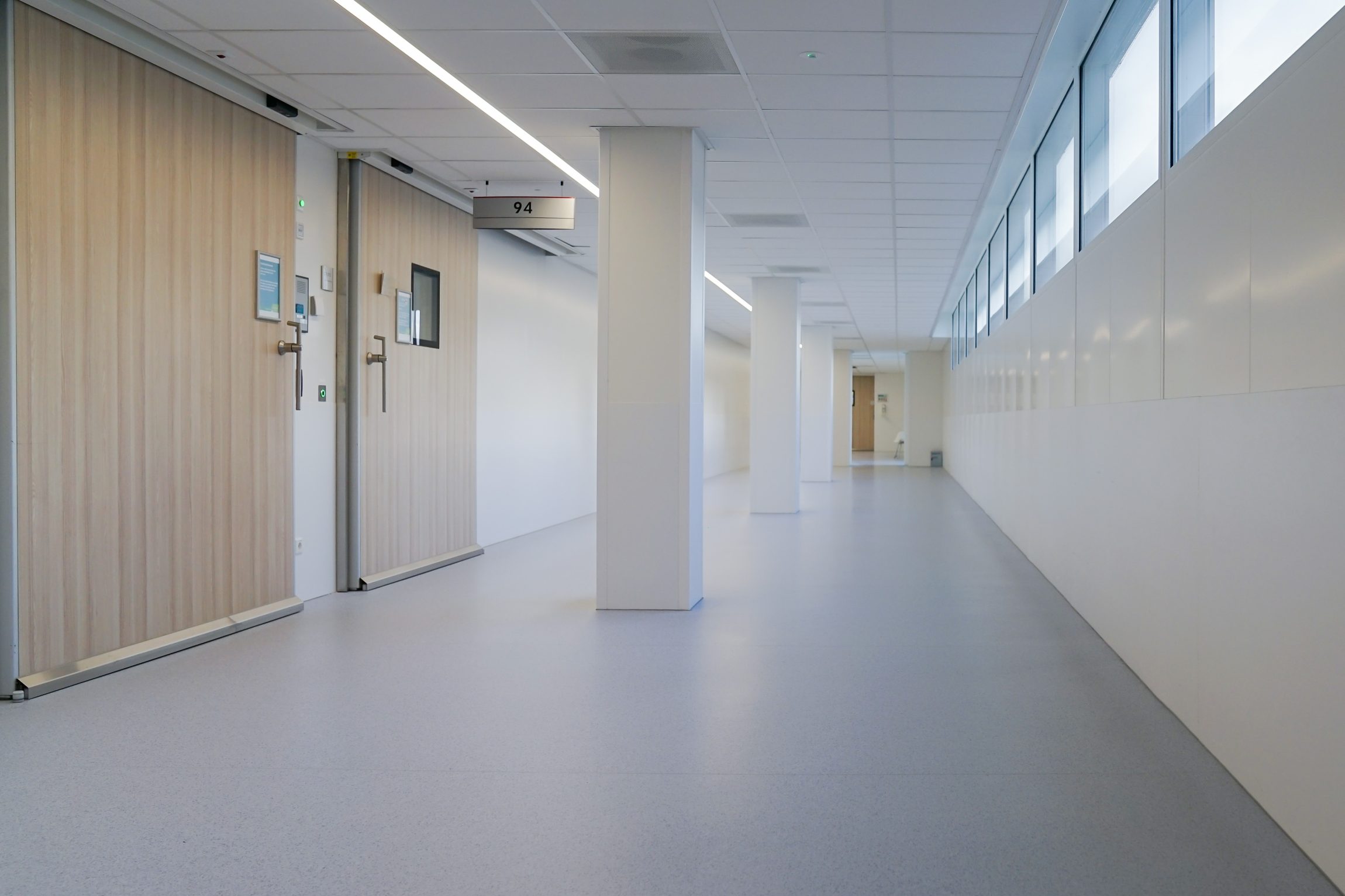 Specification of clinical-grade flooring, capped and coved skirting, and wipe-clean finishes