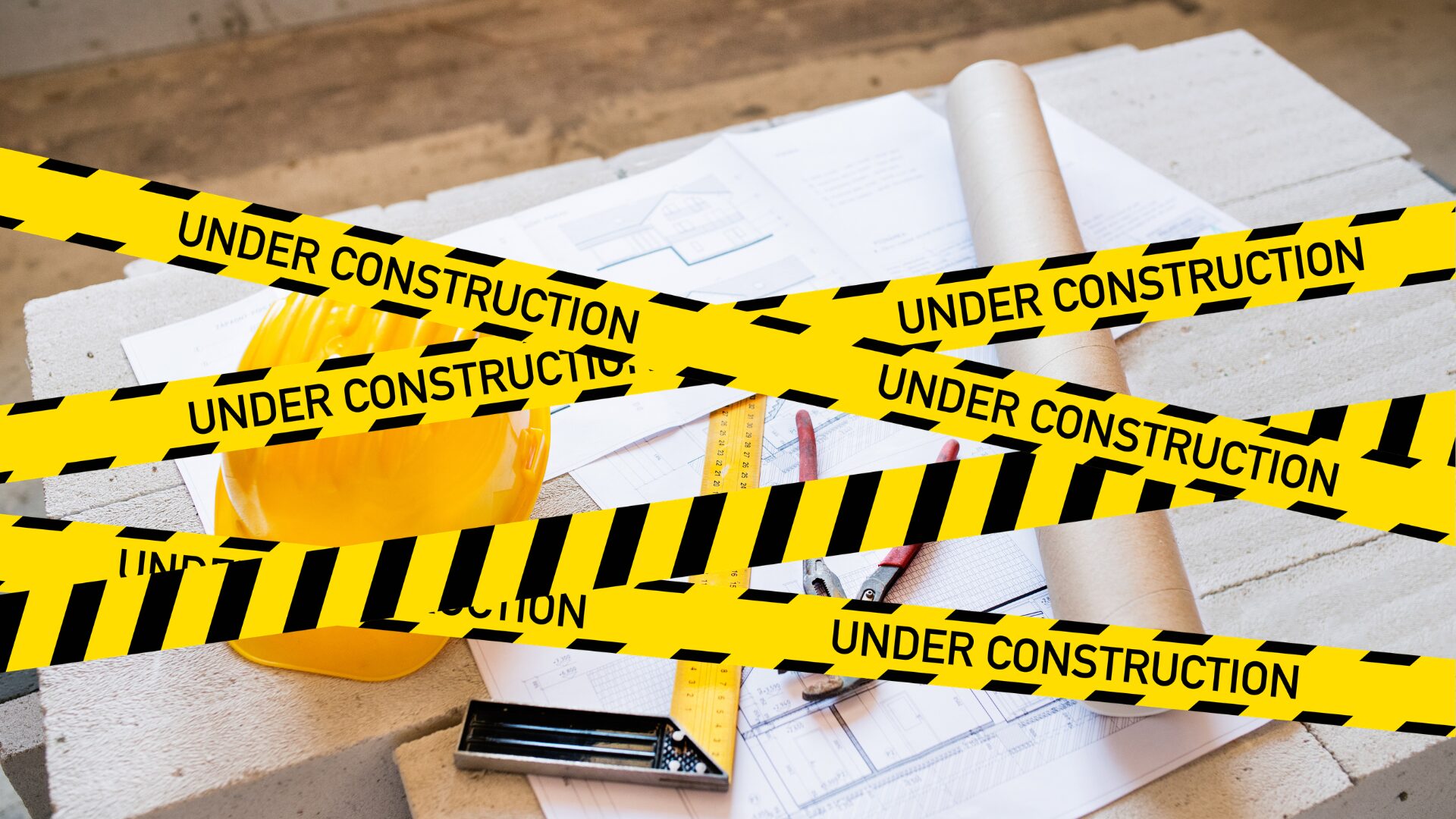 Construction plans and a hard hat behind under-construction safety tape, representing a clinic refurbishment project delayed by a contractor.